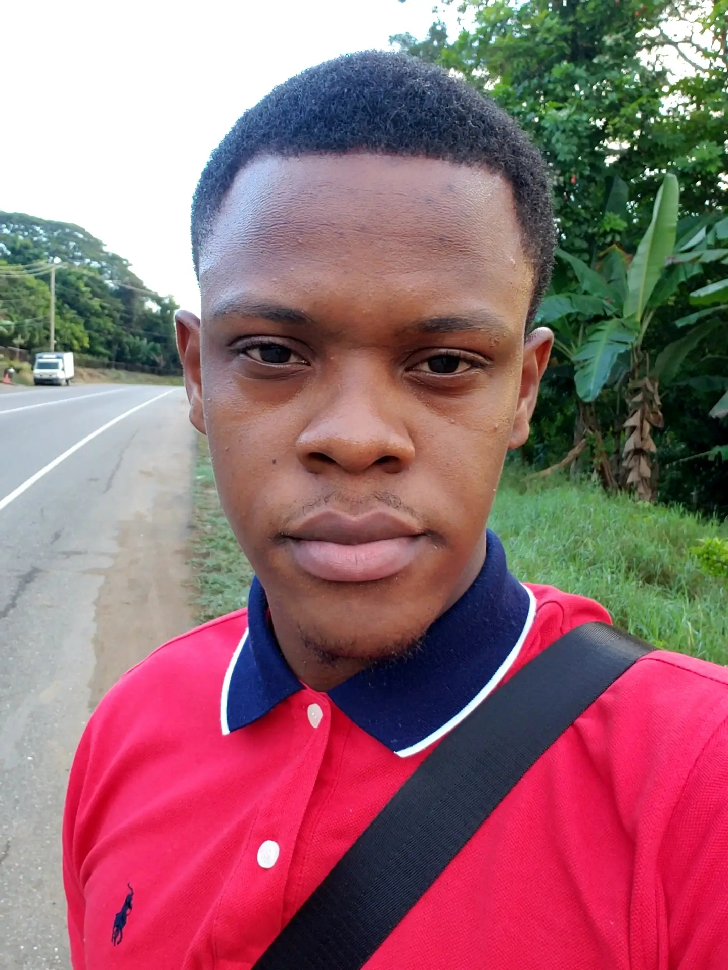 a selfie of charles in a red polo shirt 